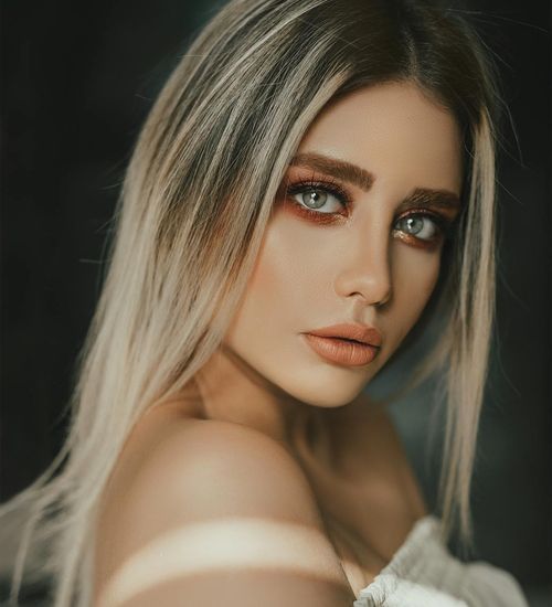 Woman with a calm and focused expression, looking forward.